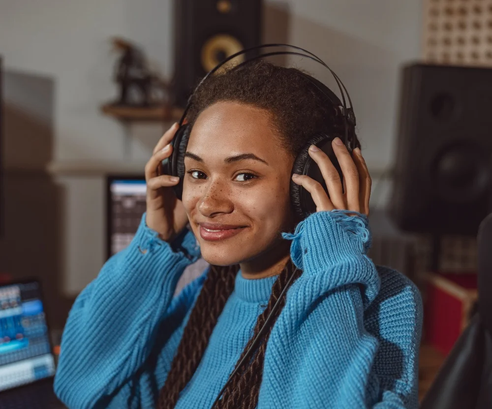 woman holding headphones on her head